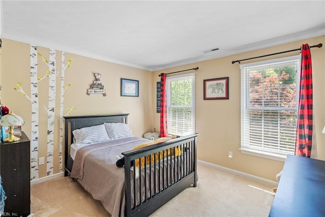 bedroom with light colored carpet, baseboards, and crown molding