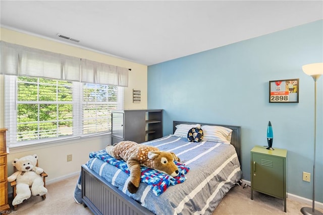 bedroom featuring light carpet and baseboards