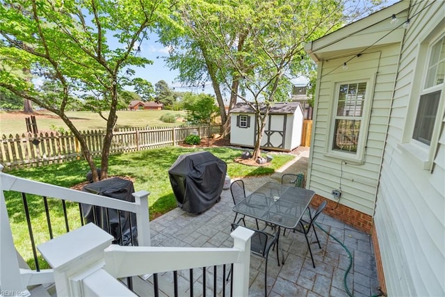 view of patio / terrace featuring a shed, grilling area, an outdoor structure, and outdoor dining area