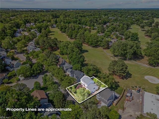 aerial overview of property's location with a heavily wooded area, a local golf course, and property parcel outlined