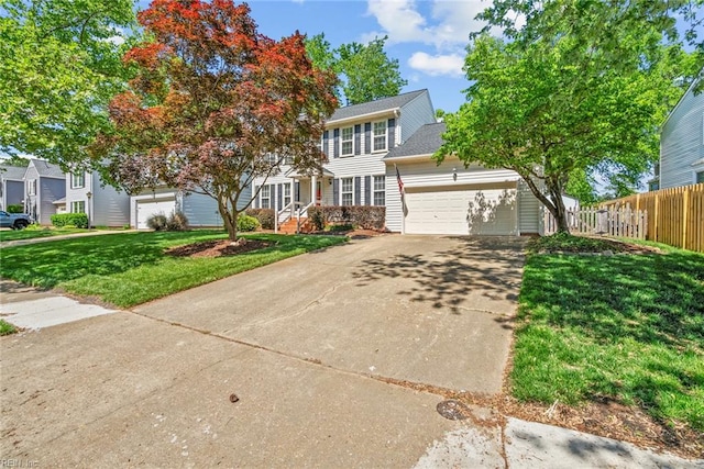 colonial home with a garage and concrete driveway