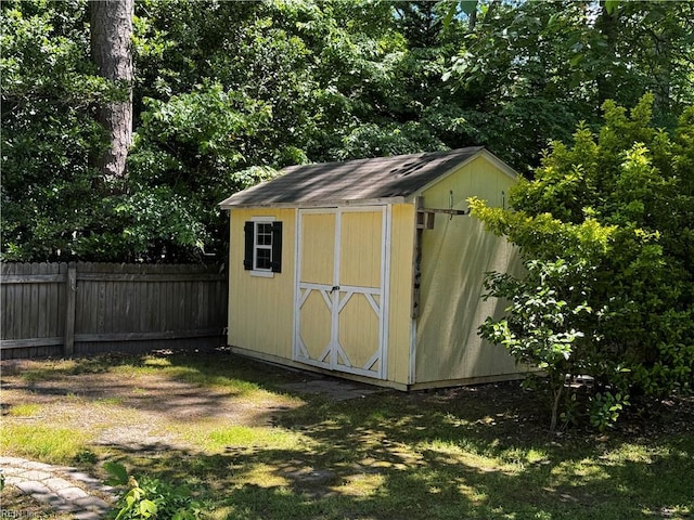 view of shed featuring fence