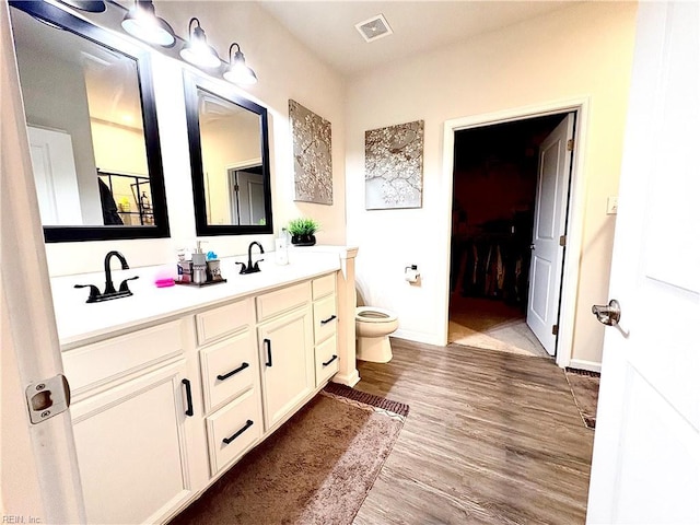 3432 Foxglove Dr, Toano, VA 23168 - full bathroom featuring toilet, double vanity, wood finished floors, and baseboards