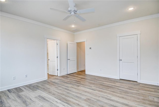 interior space with crown molding, wood finished floors, baseboards, and recessed lighting