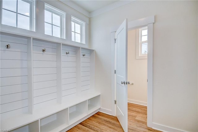mudroom with light wood-style floors and baseboards