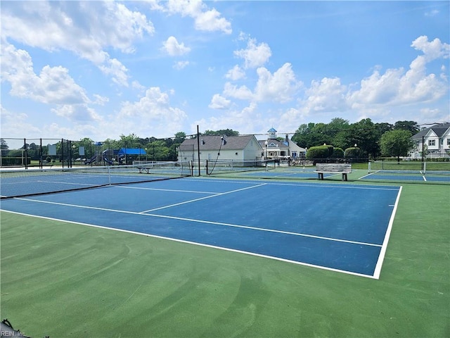 view of tennis court featuring fence