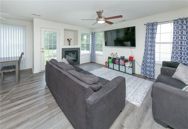 1242 Woods Edge Cir, Suffolk, VA 23434 - living room with ceiling fan, wood finished floors, a glass covered fireplace, and baseboards