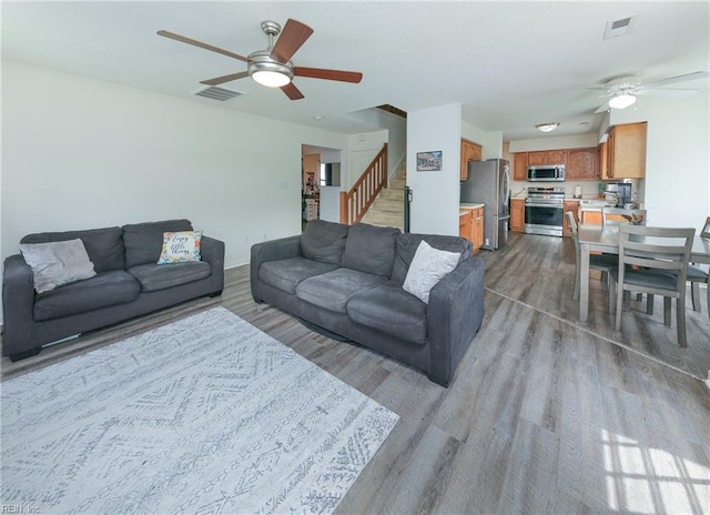 1242 Woods Edge Cir, Suffolk, VA 23434 - living room featuring a ceiling fan, wood finished floors, and stairway