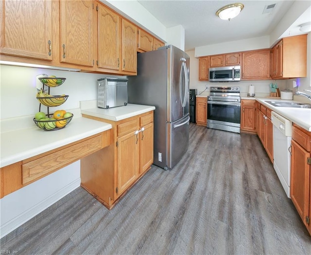 1242 Woods Edge Cir, Suffolk, VA 23434 - kitchen with stainless steel appliances, a sink, wood finished floors, and light countertops