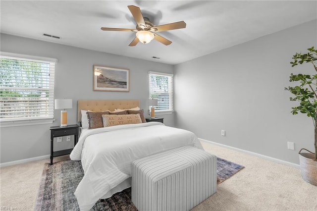 carpeted bedroom with baseboards and a ceiling fan