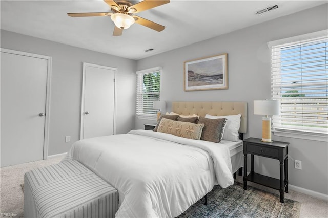carpeted bedroom featuring baseboards and a ceiling fan