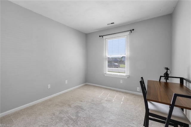 unfurnished office featuring carpet flooring and baseboards