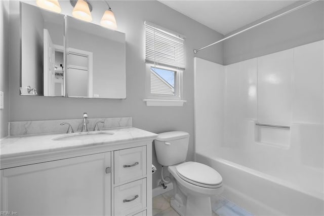 full bath featuring vanity, toilet,  shower combination, and baseboards