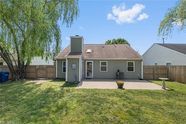 back of house featuring a patio area, a chimney, cooling unit, and a gate