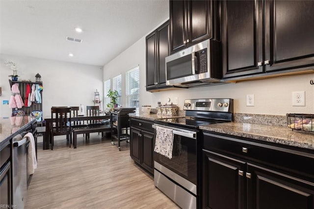 909 Porte Crayon St, Chesapeake, VA 23323 - kitchen with stainless steel appliances, dark stone counters, light wood-type flooring, and recessed lighting