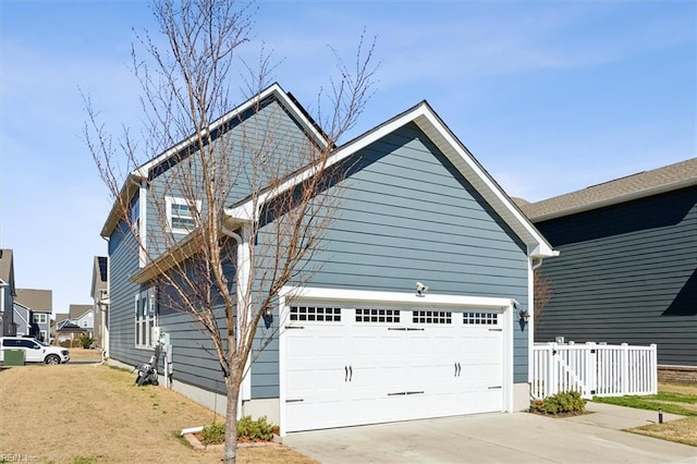 909 Porte Crayon St, Chesapeake, VA 23323 - view of front facade featuring driveway, fence, and an attached garage
