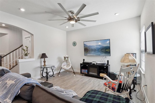 909 Porte Crayon St, Chesapeake, VA 23323 - living area with arched walkways, wood finished floors, a ceiling fan, stairway, and recessed lighting
