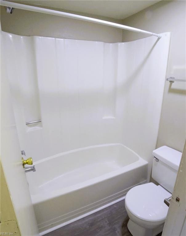 full bathroom with toilet, wood finished floors, and tub / shower combination