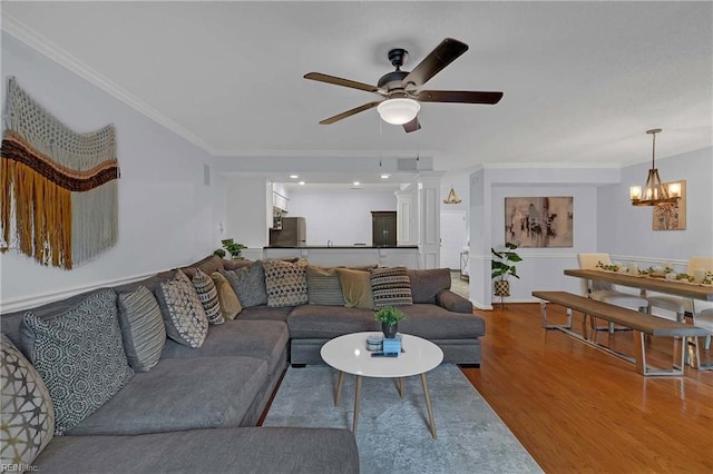 112 Two Turkey Run, Yorktown, VA 23692 - living room with crown molding, ceiling fan, a chandelier, and wood finished floors