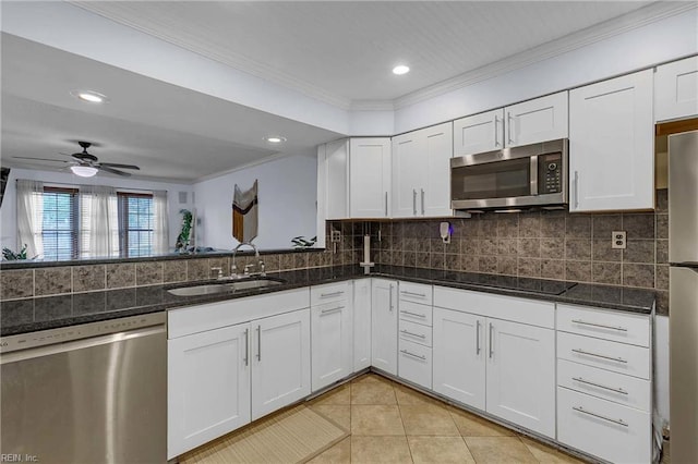 112 Two Turkey Run, Yorktown, VA 23692 - kitchen with appliances with stainless steel finishes, a sink, ornamental molding, light tile patterned floors, and white cabinets