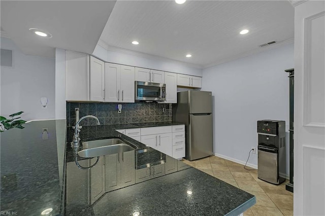 112 Two Turkey Run, Yorktown, VA 23692 - kitchen with appliances with stainless steel finishes, a sink, white cabinets, dark stone counters, and tasteful backsplash