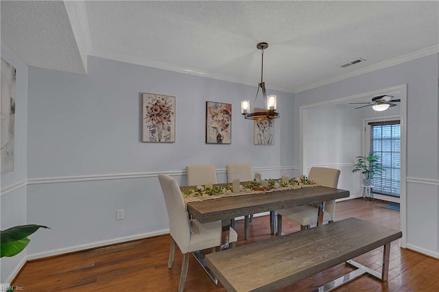 112 Two Turkey Run, Yorktown, VA 23692 - dining room with wood finished floors, a textured ceiling, ornamental molding, a chandelier, and baseboards