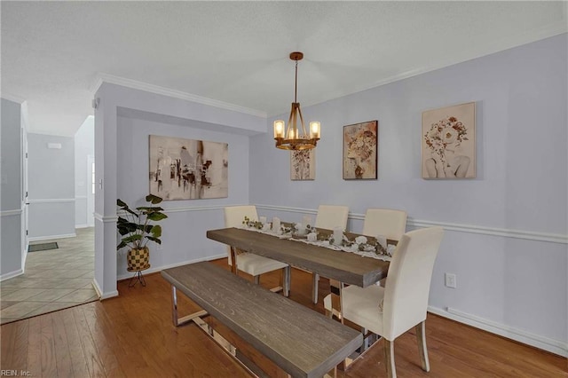 112 Two Turkey Run, Yorktown, VA 23692 - dining room featuring a chandelier, wood finished floors, crown molding, and baseboards