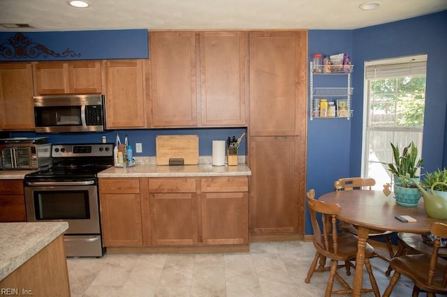 1132 Van Loen Dr, Virginia Beach, VA 23453 - kitchen featuring appliances with stainless steel finishes, light countertops, brown cabinets, and recessed lighting