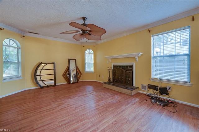 4813 Shallowford Cir, Virginia Beach, VA 23462 - unfurnished living room featuring wood finished floors, a textured ceiling, ornamental molding, plenty of natural light, and a fireplace with raised hearth