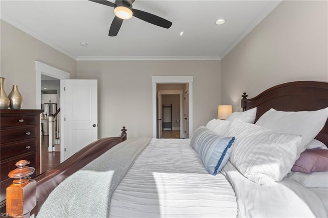 bedroom featuring crown molding, wood finished floors, and ceiling fan