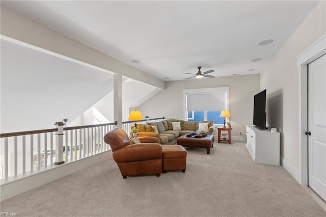 living room featuring a ceiling fan and light colored carpet