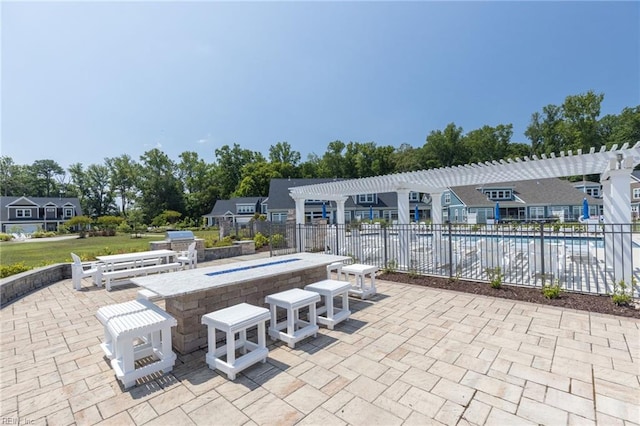 view of patio featuring a pergola, fence, and a community pool