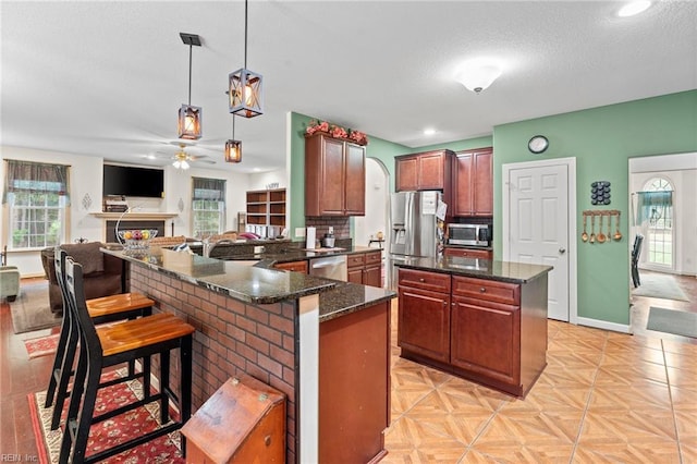 2234 Creekway Dr, Smithfield, VA 23430 - kitchen featuring stainless steel appliances, a ceiling fan, arched walkways, hanging light fixtures, and a sink