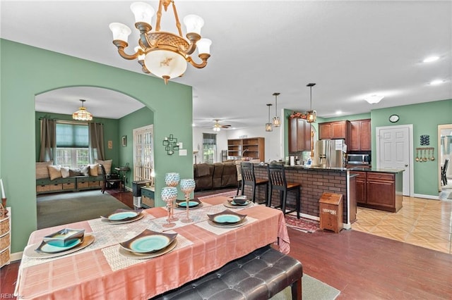 2234 Creekway Dr, Smithfield, VA 23430 - dining room with arched walkways, a chandelier, light wood-style flooring, and healthy amount of natural light