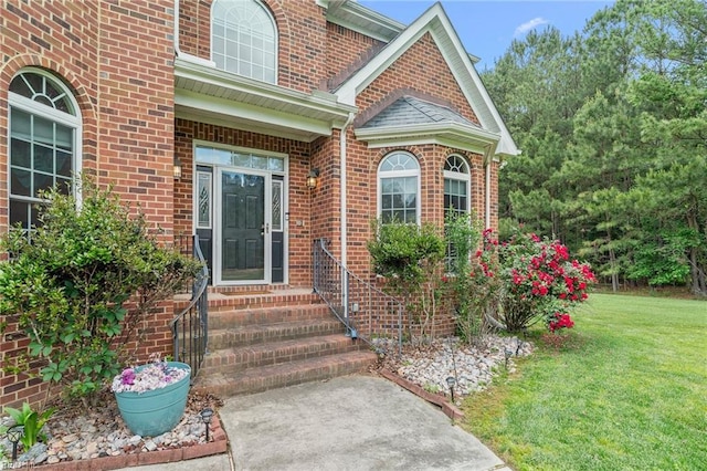 2234 Creekway Dr, Smithfield, VA 23430 - view of exterior entry featuring a yard and brick siding