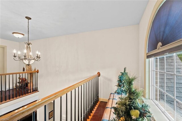 2234 Creekway Dr, Smithfield, VA 23430 - hallway featuring a chandelier, wood finished floors, plenty of natural light, and an upstairs landing