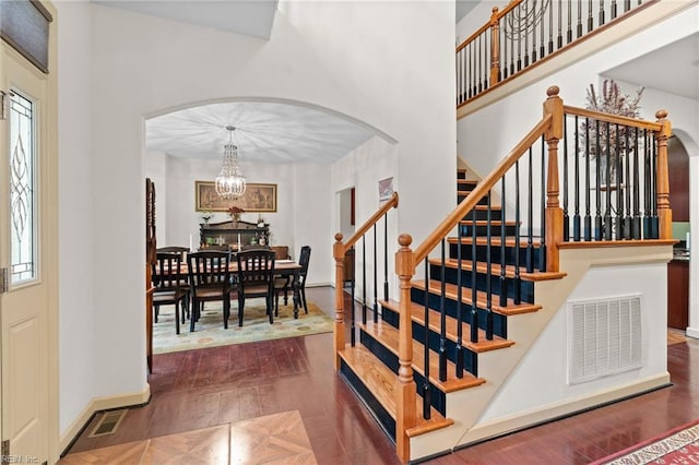 2234 Creekway Dr, Smithfield, VA 23430 - staircase with arched walkways, a chandelier, wood finished floors, and a high ceiling