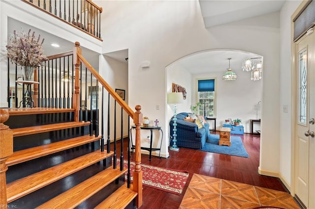 2234 Creekway Dr, Smithfield, VA 23430 - foyer entrance with arched walkways, stairs, baseboards, wood finished floors, and a towering ceiling