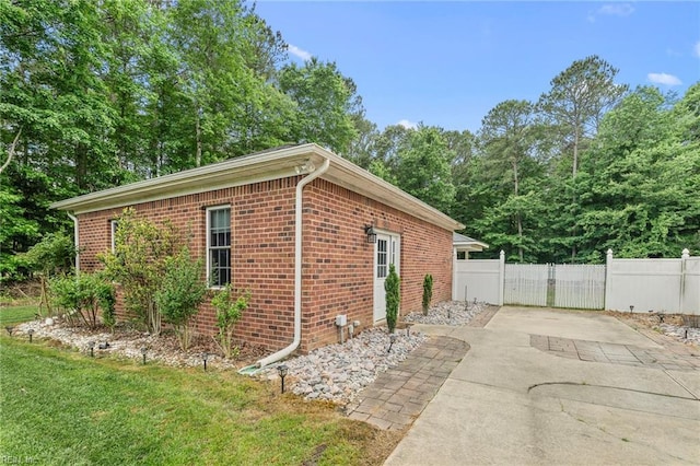 2234 Creekway Dr, Smithfield, VA 23430 - view of property exterior with fence, brick siding, concrete driveway, and a patio