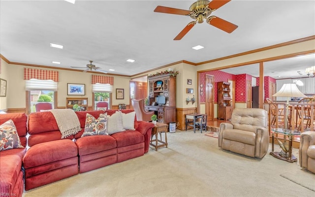 living room featuring ceiling fan, wainscoting, carpet, and crown molding