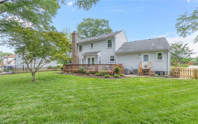 rear view of property featuring a chimney, a deck, central AC unit, and entry steps
