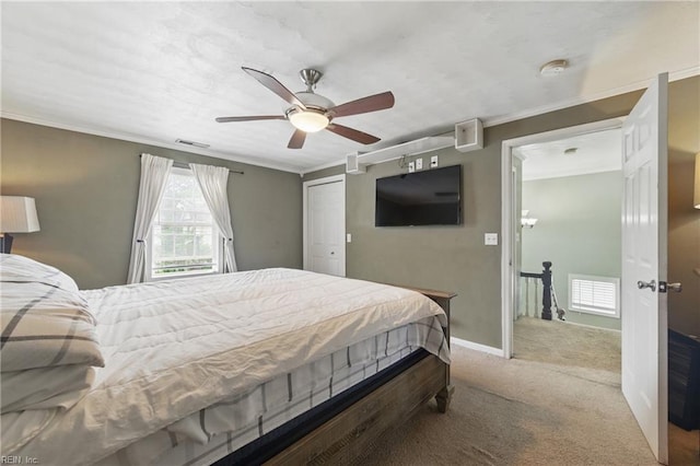 bedroom featuring carpet floors, ornamental molding, ceiling fan, and baseboards
