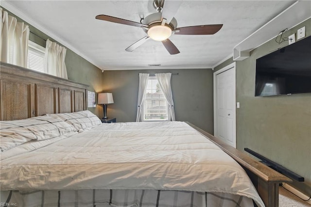 bedroom with ornamental molding and a ceiling fan
