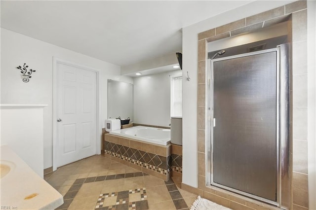 bathroom featuring tile patterned flooring, a shower stall, and a garden tub
