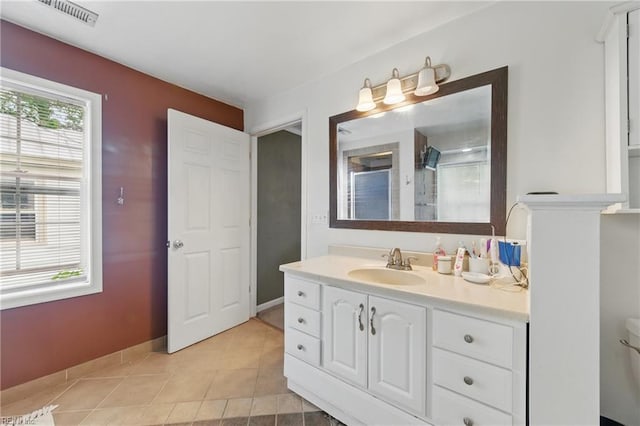 bathroom with tile patterned flooring, vanity, a shower stall, and toilet