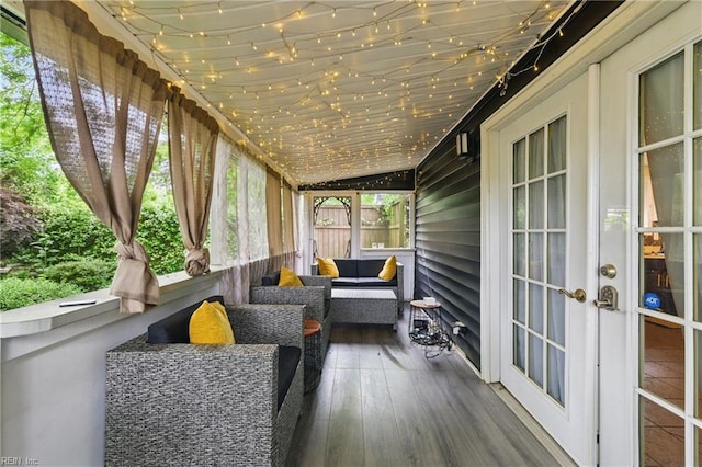 sunroom / solarium featuring french doors and lofted ceiling