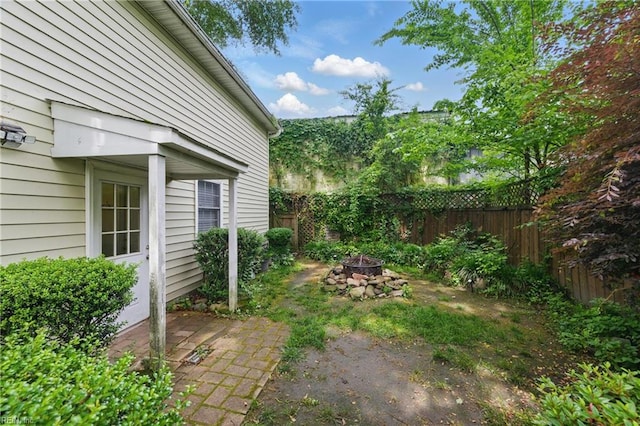 fenced backyard featuring a fire pit and a patio