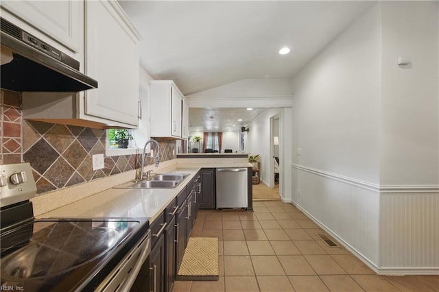 kitchen with appliances with stainless steel finishes, a sink, under cabinet range hood, light countertops, and white cabinets
