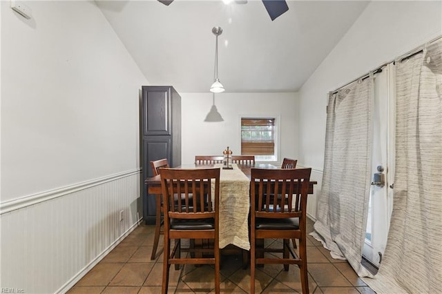 tiled dining room featuring ceiling fan and lofted ceiling