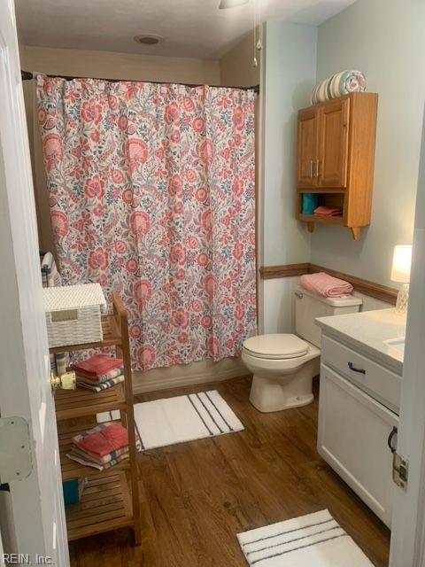 949 Kings Fork Rd, Suffolk, VA 23434 - full bath featuring wood finished floors, toilet, shower / bath combination with curtain, and vanity